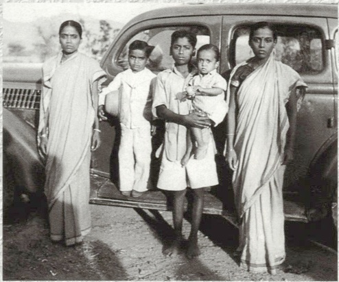 Sathya Sai (on the cars step) with His siblings